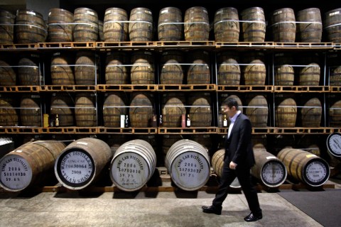 Ian Chang, a blender for Kavalan Whisky, walks past barrels inside an aging warehouse and distillery in Ilan, Taiwan, February 9, 2010 (REUTERS / Nicky Loh)