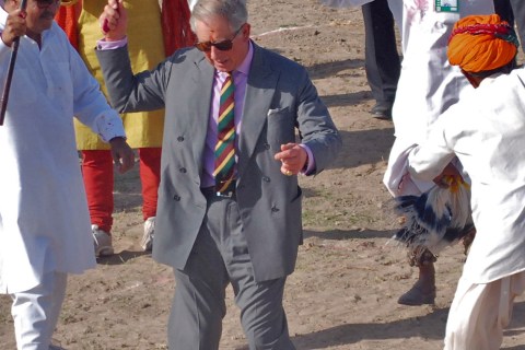 Britain's Prince Charles dances with villagers at Tolasar