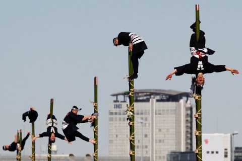 Members of the Edo Firemanship Preservation Association perform atop bamboo ladders during a New Year demonstration by the fire brigade in Tokyo