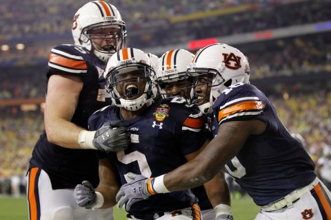 Auburn Tigers' Michael Dyer celebrates with teammates Brandon Mosley and Kodi Burns after a run to the half yard line against the Oregon Ducks in the fourth quarter in the NCAA BCS National Championship college football game in Glendale