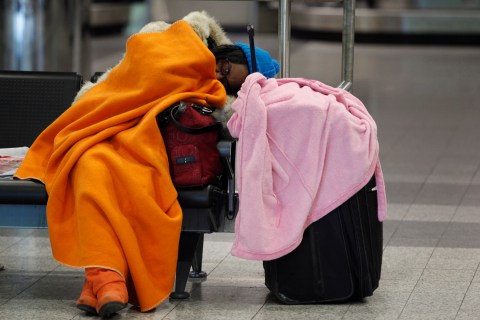 A passenger sleeps at New York's LaGuardia Airport (REUTERS / Jessica Rinaldi)