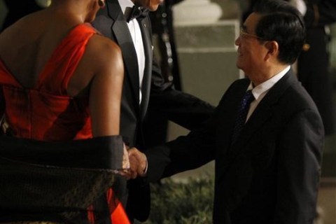 U.S. President Barack Obama and first lady Michelle Obama greet China's President Hu Jintao as he arrives for a State Dinner in his honor at the White House in Washington
