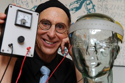 Professor Allan Snyder displays a "thinking cap"
