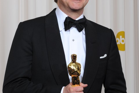 Actor Colin Firth holds the award for Be