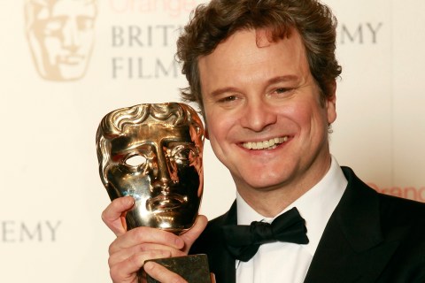Colin Firth holds the award for best actor at the BAFTAs