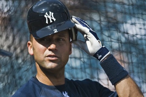 New York Yankees' Jeter pulls on his batting helmet during a full-squad workout at the team's spring training camp in Tampa