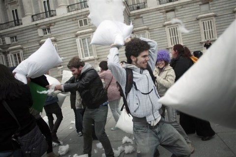 Young people take part in a pillow fight outside Madrid's Royal Palace