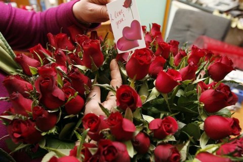 A florist prepares roses for Valentine's Day at a flower shop in Tirana