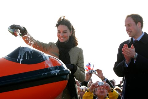 Prince William watches Kate Middleton pour champagne over the 'Hereford Endeavour' lifeboat