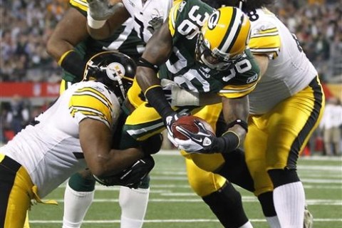 Packers' Collins is hit by Steelers' Scott as he dives in for a touchdown after intercepting Steelers' Roethlisberger during the NFL's Super Bowl XLV football game in Arlington