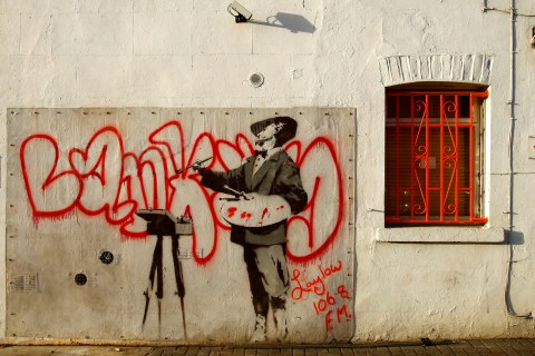 A Banksy painting is seen on a wall in Portobello Road, west London