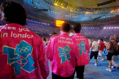Participants wear shirts with the logo of the London 2012 Olympics during the closing ceremony of the Beijing 2008 Olympic Games at the National Stadium