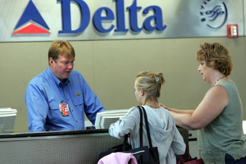 Delta Air Lines ticket agent checks in passengers at Detroit Metropolitan Airport.