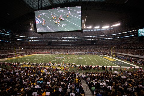 The Pittsburgh Steelers play the Green Bay Packers under a giant screen in Cowboys Stadium during the NFL's Super Bowl XLV football game in Arlington