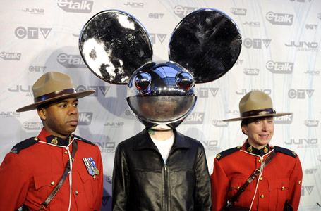 Recording artist 'deadmau5' poses with RCMP officers during the 40th Juno Awards in Toronto