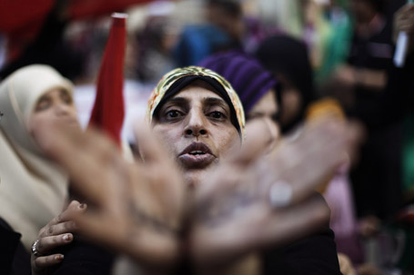A woman takes part in a rally supporting coalition air strikes in Libya