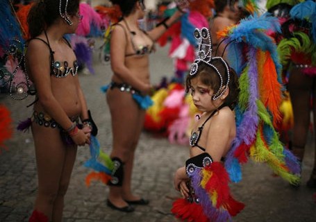 A child waits to take part in a samba parade during a carnival in Sesimbra village
