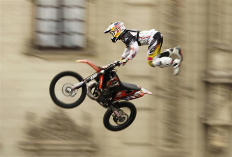 A motorcyclist performs during the Red Bull X-Fighters Jams motocross exhibition in front of the government palace in Lima