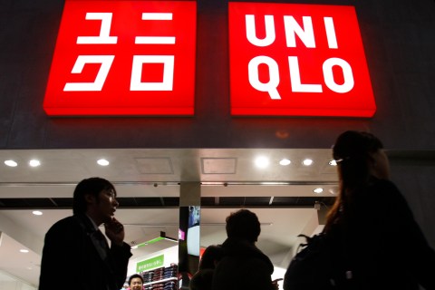 Pedestrians walk past  Fast Retailing's Uniqlo casual clothing store in Tokyo
