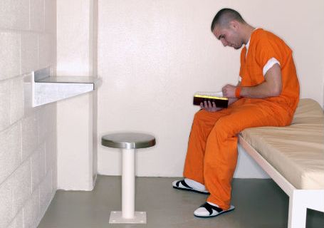 Inmate reading Bible