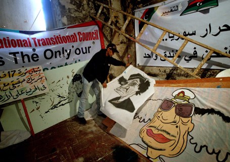 A Libyan rebel artist shows caricatures