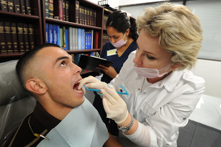 Diemo Landeros (L) is checked by dentist
