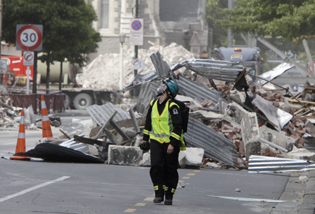 A rescue worker walks through the rubble in central Christchurch