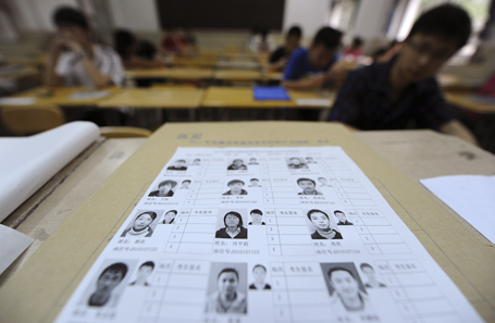 A name list with photographs of students are seen as examinees sit at their desks before the National College Entrance Exams, in Hefei, Anhui province