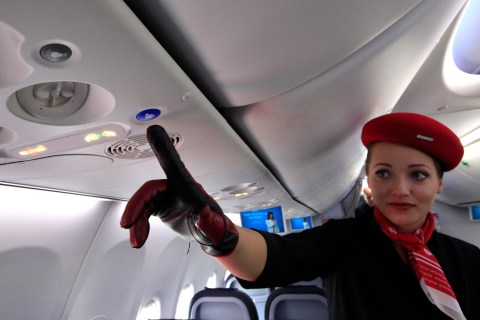 An airberlin flight attendant demonstrates the new call button in the Boeing 737 during 49th Paris Air Show 