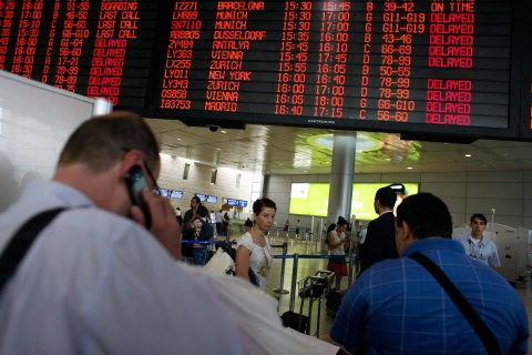 Passengers queue for security checks near information boards at the Ben Gurion International Airport near Tel Aviv