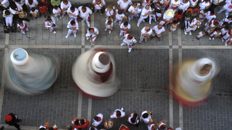 Festival goers watch a dance by traditional giant figures on the seventh day of the San Fermin festival in Pamplona.