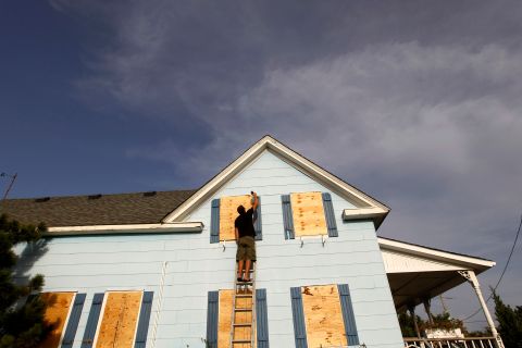 Lee Rogers boards up the windows of his friend's house at Cape Hatteras National Seashore in Salvo, North Carolina