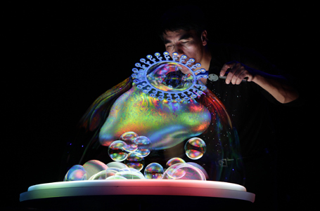 Canadian bubble artist Fan Yang performs during "The Gazillion Bubble Show" in Beijing