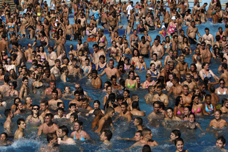 People are seen in a pool at the Palatinus outdoor spa in Budapest