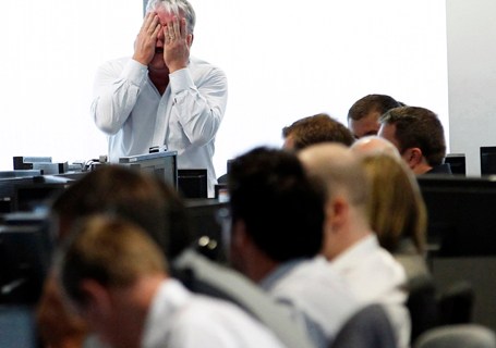 A broker reacts at BGC Partners at Canary Wharf financial district in London