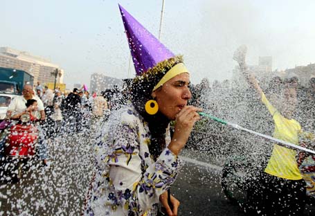 A girl takes part in celebrations for Eid al-Fitr, which marks the end of the Muslim holy month of Ramadan, on Tahrir square in Cairo