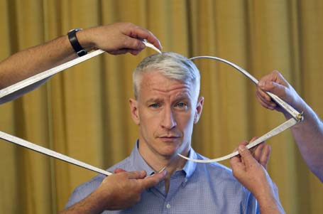 Television journalist Anderson Cooper poses for a portrait while being measured for a wax figure by Madame Tussauds in New York