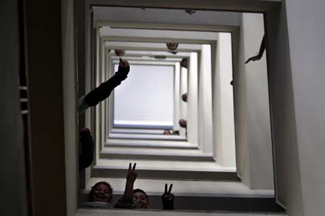 Students gesture as they walk down the stairs during an occupation of the Chile's Education Ministry at Santiago