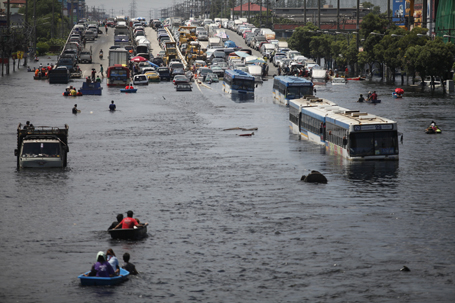 Vehicles are parked on an elevated highway to avoid floodwater in the north of Bangkok