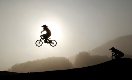 Cyclists warm up at sunrise before their heats in the men's BMX cycling competition final at the Pan American Games in Guadalajara
