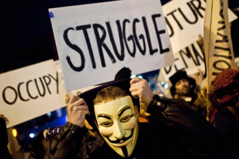 An Occupy Wall Street protestor wearing a Guy Fawkes mask takes part in the 39th Annual Halloween Parade in New York