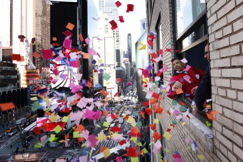 Organizers toss confetti from a window during the annual "air worthiness test" in Times Square during preparations for New Years Eve celebrations in New York