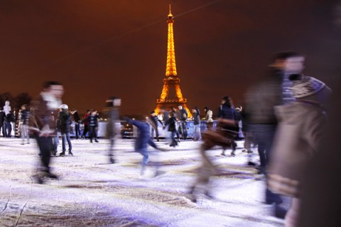 People skate on an ice rink at Trocadero near the Eiffel Tower in Paris