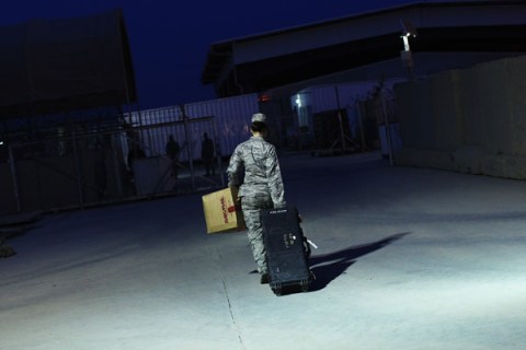 U.S. Air Force Major Stacie Shafran carries her luggage to a loading paddock while waiting for her departure from Iraq at the former U.S. Sather Air Base near Baghdad
