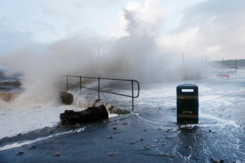Waves crash against the promenade in Largs in west Scotland
