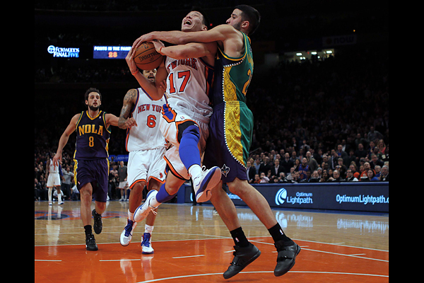 New York Knicks point guard Jeremy Lin is fouled by New Orleans Hornets point guard Greivis Vasquez in the second half of their NBA basketball game at Madison Square Garden in New York