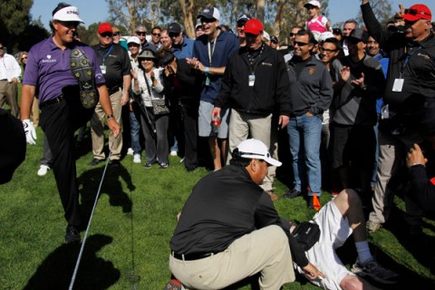 Mickelson of the U.S. steps over the rope to check on spectator Prendergast during the Northern Trust Open golf tournament in Los Angeles