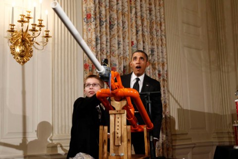 U.S. President Obama reacts as Hudy launches a marshmallow from his Extreme Marshmallow Cannon during the second White House Science Fair in Washington