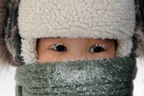 A child, with eyelashes covered with hoarfrost, is seen along a street in the eastern Siberian city of Yakutsk