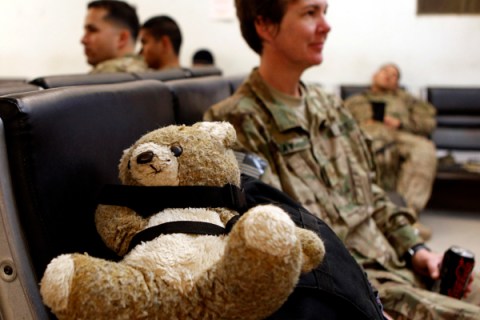 Major Gray, occupational therapist of Task Force Bronco sits next to her teddy bear while waiting for a flight to return home to the U.S. at the pax terminal of FOB Fenty in Nangarhar province, eastern Afghanista